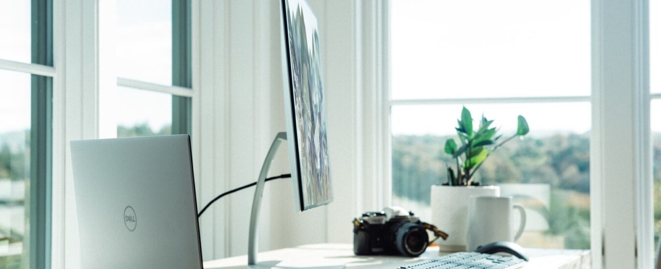 silver laptop on white table